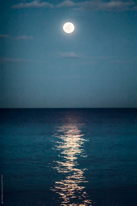 "Night,reflection Of The Full Moon In The Sea, Colorful" by Stocksy Contributor "Igor Madjinca ...