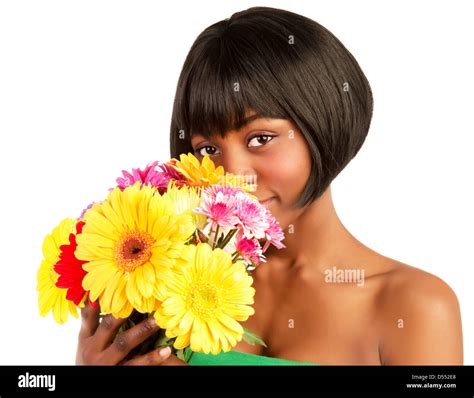 Attractive young black woman holding in hands fresh colorful flowers isolated on white ...