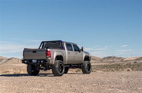 Gray Lifted GMC Sierra Sporting a Set of Gloss Black TIS Rims — CARiD ...