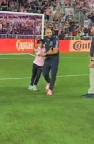 Lionel Messi's bodyguard quickly grabbed the young fan as he rushed onto the field to meet the ...