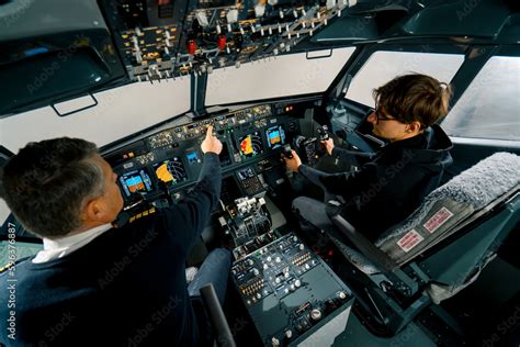 An experienced pilot instructs a young student before a training flight ...