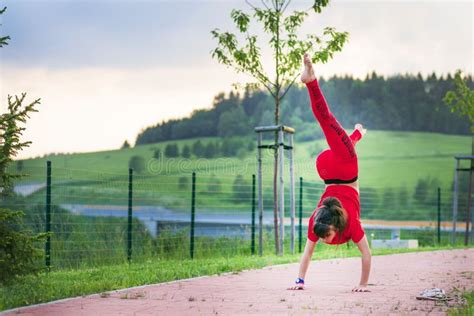 Girl Acrobatics on the Street.a Girl Does Acrobatic Stunts on the Street Stock Photo - Image of ...