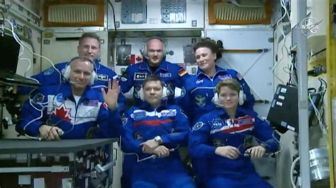 Astronauts wave aboard the ISS after spending eight hours in a tiny ...