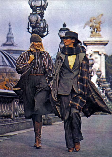 two women walking down the street in coats and hats, one is talking on her cell phone