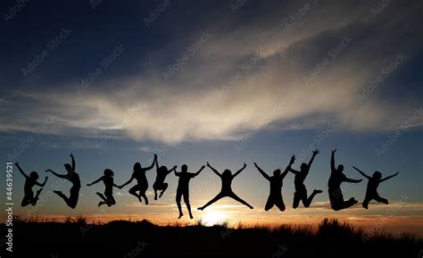 silhouette of kids jumping on beach in sunset Stock Photo | Adobe Stock