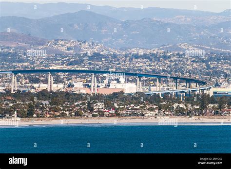 the Coronado Bridge from San Diego to Coronado Island showing shipyards under the bridge with ...