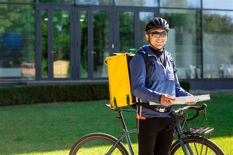 Premium Photo | Portrait of bicycle courier with yellow bag and bike