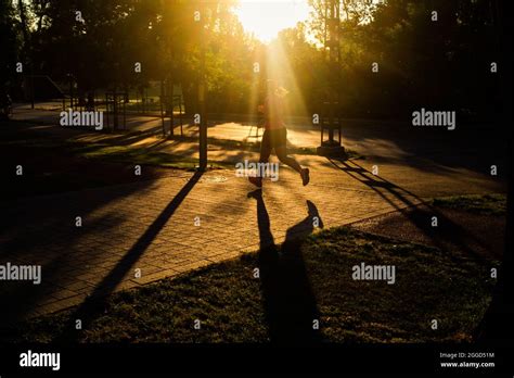 silhouette of person running in park at sunset healthy active lifestyle Stock Photo - Alamy