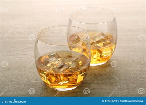 Two Glasses with Whiskey with Ice Cubes Stock Photo - Image of ...