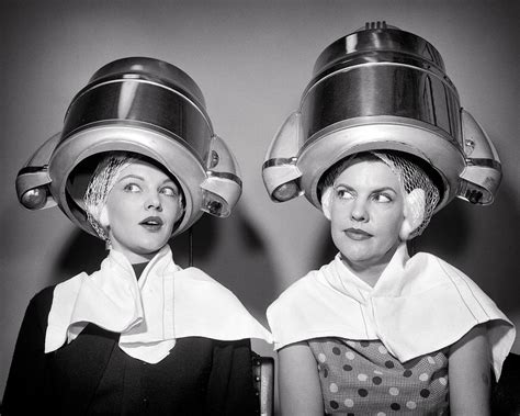 1950s Two Women Sitting Under Beauty Salon Hair Dryers Wearing Hairnets Towels Talking Gossip ...