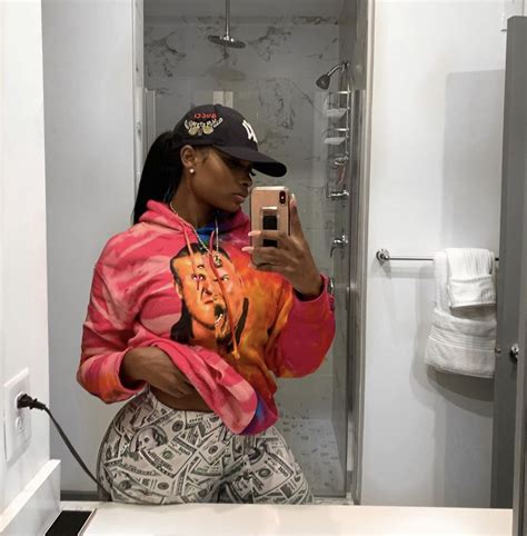 a woman taking a selfie in a bathroom mirror with her phone up to her ear