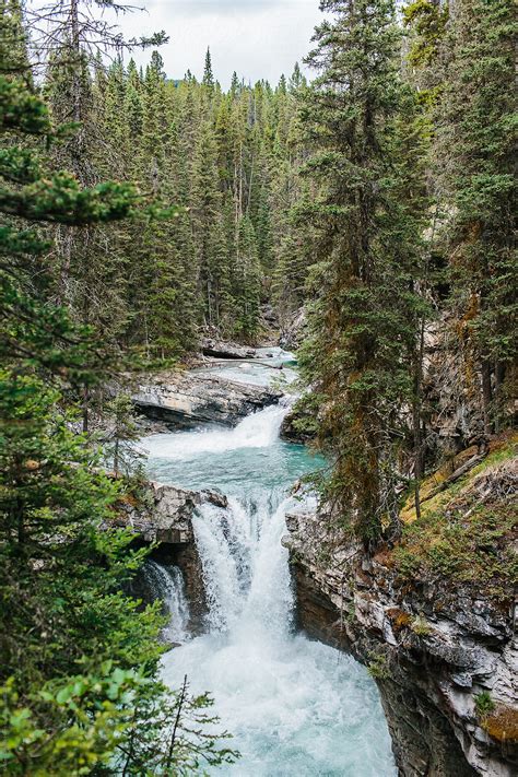 "A Waterfall In Canada" by Stocksy Contributor "Kristen Curette & Daemaine Hines" - Stocksy