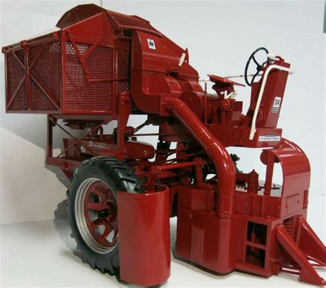 a red tractor is shown on a white surface with the front wheels facing away from the camera