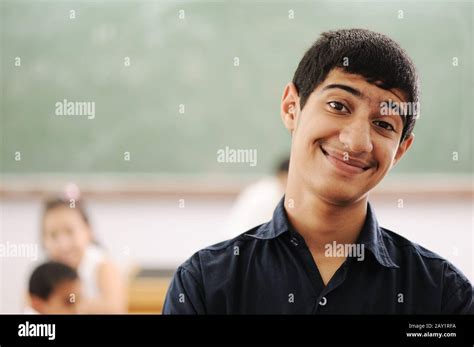 Happy student in classroom Stock Photo - Alamy