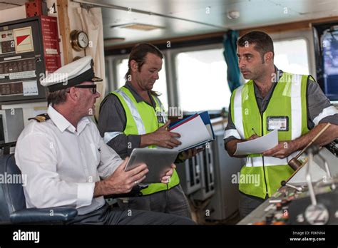 Ship crew and captain on bridge Stock Photo - Alamy