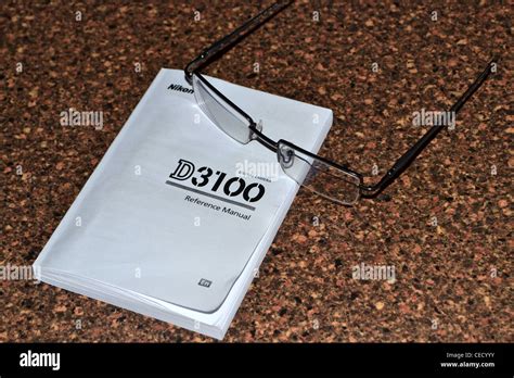 nikon D3100 manual with glasses Stock Photo - Alamy