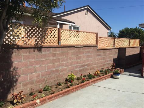 Added lattice privacy fence topper to cinder block wall - Yelp | Cinder block walls, House ...