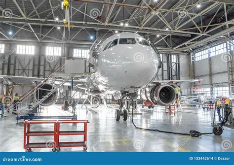 Commercial Aircraft Jet on Maintenance of Engine and Fuselage Check Repair in Airport Hangar ...