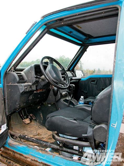 the interior of an old blue truck with its door open