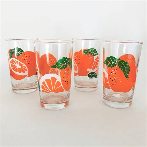 four glasses with oranges painted on them