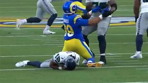 Geno Smith suffers elbow injury on big hit from Aaron Donald