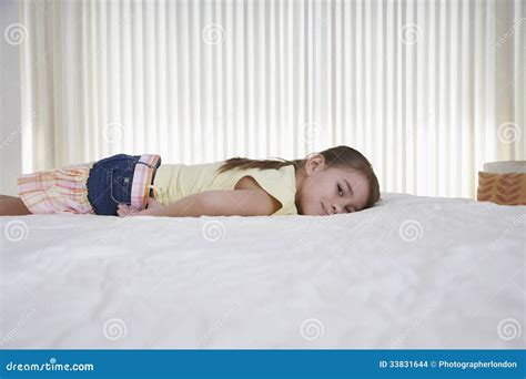 Happy Little Girl Lying In Bed Stock Photography | CartoonDealer.com #33831644