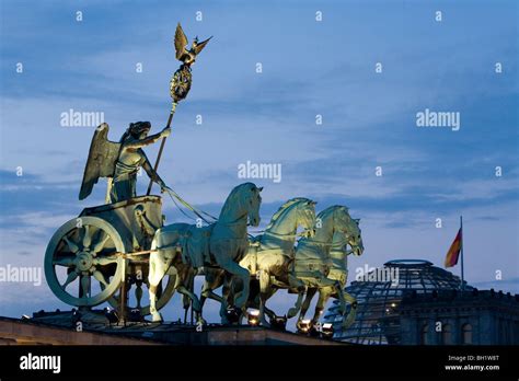 Quadriga, horse and chariot sculpture on Brandenburg Gate, in the background the Reichstag ...