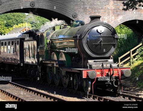 LNER B12 8572 steam locomotive in apple green livery pulls out of Weybourne Station on The North ...