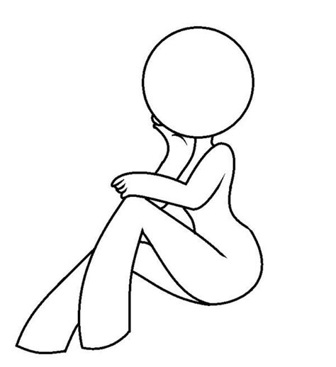 a person sitting on the ground with their legs crossed and arms folded over their knees