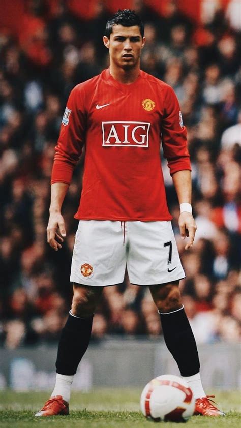 a man standing next to a soccer ball on a field