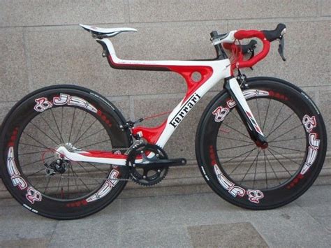 a red and white bike parked next to a wall