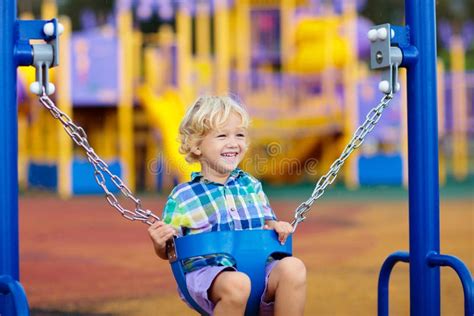 Child on Playground. Swing Kids Play Outdoor Stock Image - Image of playful, outside: 254580427