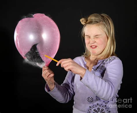 Girl Popping A Balloon Photograph by Ted Kinsman - Fine Art America