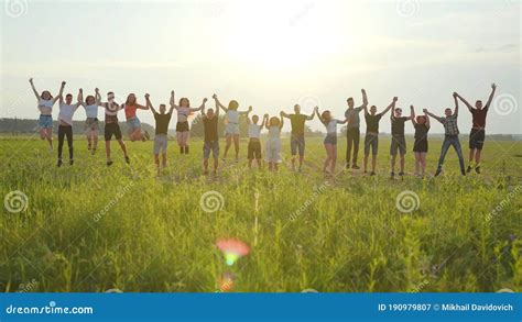 Friends are Jumping Holding Hands at Sunset. Stock Image - Image of ...