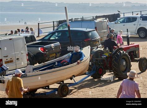 Fishing boats at Filey Beach, North Yorkshire east coast, busy with ...