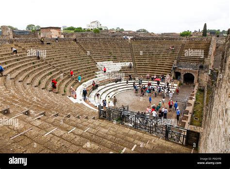 Tourists at an ancient roman amphitheatre, Pompeii Archaeological site, Pompeii, Campania, Italy ...