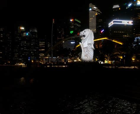 The Singapore Merlion Statue at Night with Buildings As Background Editorial Stock Photo - Image ...