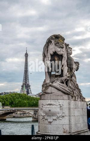 Statue of a Lioin on Bridge Alexandre III, view to Eiffel tower, Paris, France Stock Photo - Alamy