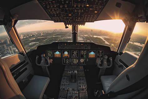 Cockpit of modern passenger jet aircraft. Pilots at work. Aerial view of modern city business ...