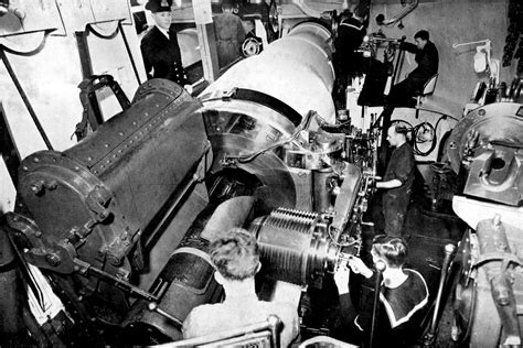 A gun crew on board HMS Iron Duke preparing to load a 13.5 inch shell into the breech of the gun ...