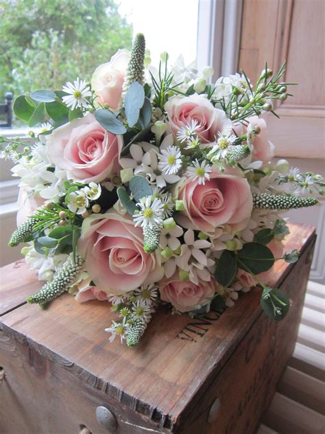 Pale pink sweet avalanche roses with white bouvardia , white veronicas , daisies and silver ...