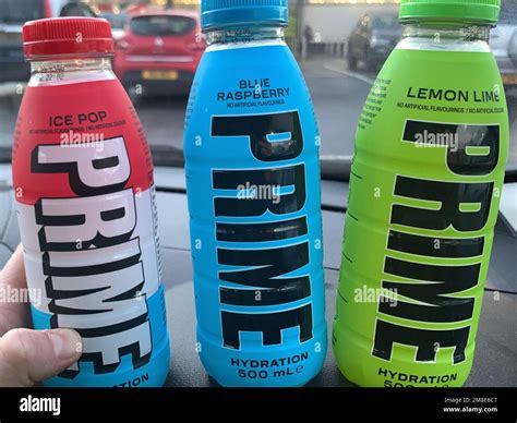 Hand holding a bottle of Prime hydration energy drink Stock Photo - Alamy