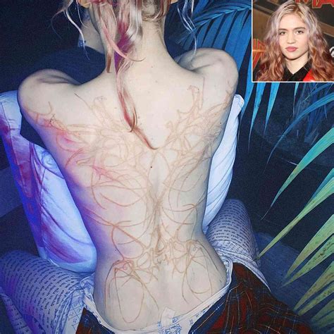 Grimes Shows Off New White Ink Back Tattoo Design