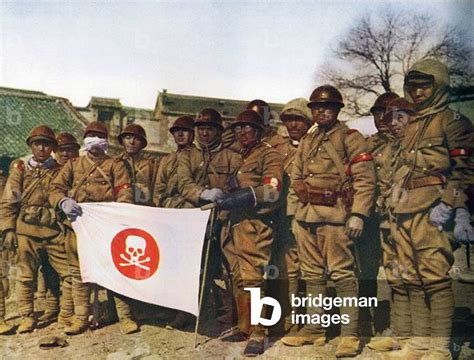 China: Japanese soldiers display a skull and cross-bones flag in ...