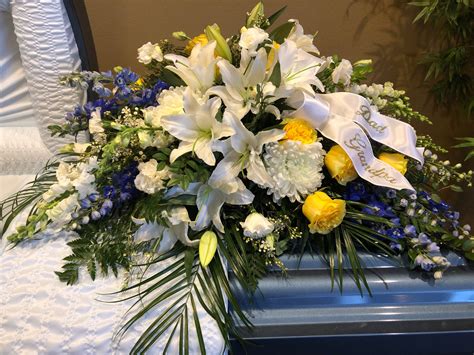 YB239 Casket spray - Beautiful combination of yellow, white and blue | Funeral flower ...