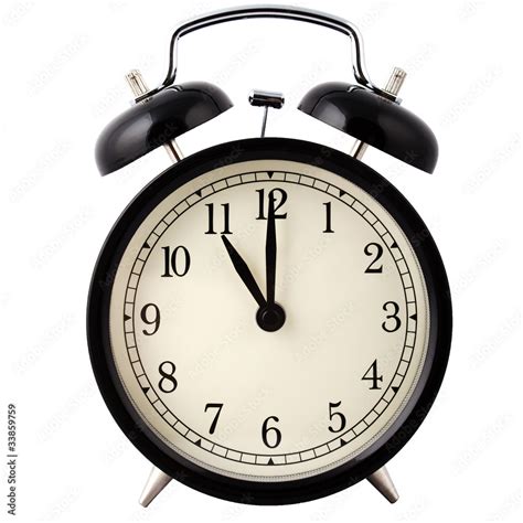 Old Alarm Clock in black and white, showing eleven o'clock. Stock Photo | Adobe Stock