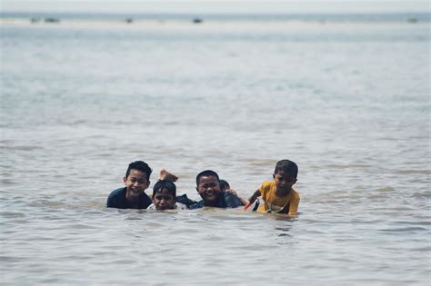 Sorong, Indonesia 2021- People on the beach 3363914 Stock Photo at Vecteezy