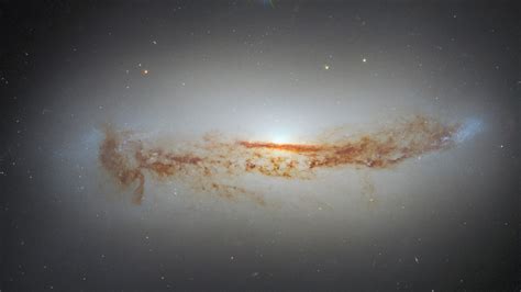 New Hubble photo shows galaxy's bright supermassive black hole cloaked in dust | Space