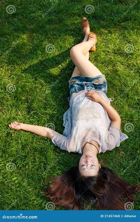 Beautiful Girl Lying Down at Grass Stock Photo - Image of color, eyes: 21457468