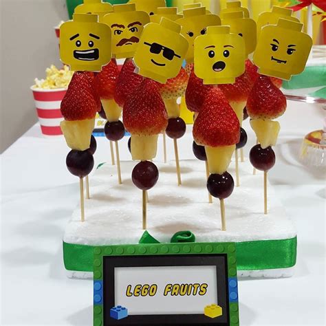 there are many lego fruit on sticks with faces and arms made to look ...